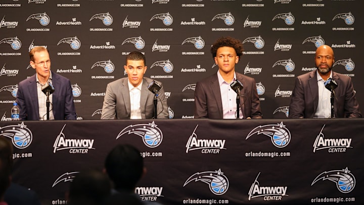 Orlando Magic president of basketball operations Jeff Weltman (left), second round draft pick Caleb Houstan (center left), first overall draft pick Paolo Banchero (center right) and Orlando Magic Coach Jamahl Mosley during a press conference at the Amway Center. 