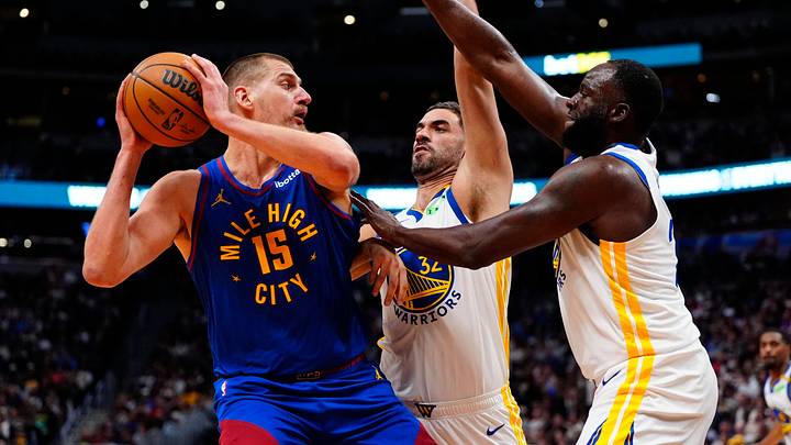 Oct 26, 2026; Denver, Colorado, USA; Golden State Warriors forward Georges Niang (32) and forward/center Draymond Green (23) defend on Denver Nuggets center Nikola Jokic (15) in the second half at Ball Arena. Mandatory Credit: Ron Chenoy-Imagn Images Oct 26, 2026; Denver, Colorado, USA; Golden State Warriors forward Georges Niang (32) and forward/center Draymond Green (23) defend on Denver Nuggets center Nikola Jokic (15) in the second half at Ball Arena. Mandatory Credit: Ron Chenoy-Imagn Images