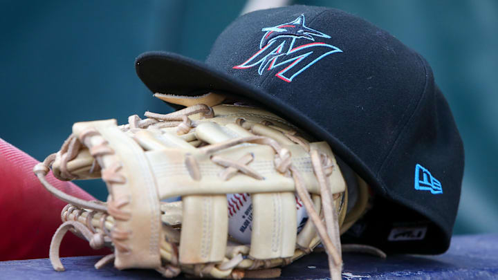 Apr 24, 2024; Atlanta, Georgia, USA; A detailed view of a Miami Marlins hat and glove in the dugout before a game against the Atlanta Braves at Truist Park. Mandatory Credit: Brett Davis-Imagn Images