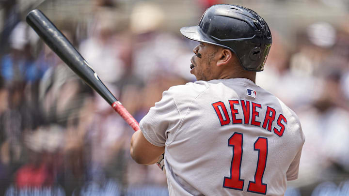 Jun 1, 2025; Cumberland, Georgia, USA; Boston Red Sox designated hitter Rafael Devers (11) follows through after hitting a double against the Atlanta Braves during the first inning at Truist Park