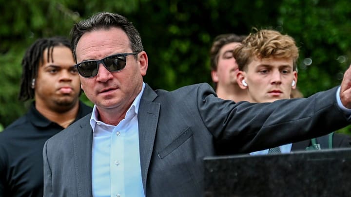 Michigan State's head coach Jonathan Smith touches the foot of the Sparty statue before the game against Florida Atlantic on Friday, Aug. 30, 2024, outside Spartan Stadium in East Lansing.