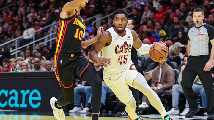 Nov 29, 2024; Atlanta, Georgia, USA; Cleveland Cavaliers guard Donovan Mitchell (45) drives the ball to the basket against Atlanta Hawks forward Zaccharie Risacher (10) during the fourth quarter at State Farm Arena. Mandatory Credit: Jordan Godfree-Imagn Images