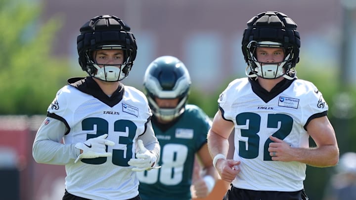 Philadelphia Eagles defensive back Cooper DeJean and safety Reed Blankenship warm up during training camp 