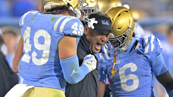 Nov 8, 2024; Pasadena, California, USA; UCLA Bruins defensive coordinator Ikaika Malloe, center, celebrates with linebacker Carson Schwesinger (49) defensive back Jaylin Davies (6) after an interception in the second half against the Iowa Hawkeyes at the Rose Bowl. Mandatory Credit: Jayne Kamin-Oncea-Imagn Images Nov 8, 2024; Pasadena, California, USA; UCLA Bruins defensive coordinator Ikaika Malloe, center, celebrates with linebacker Carson Schwesinger (49) defensive back Jaylin Davies (6) after an interception in the second half against the Iowa Hawkeyes at the Rose Bowl. Mandatory Credit: Jayne Kamin-Oncea-Imagn Images