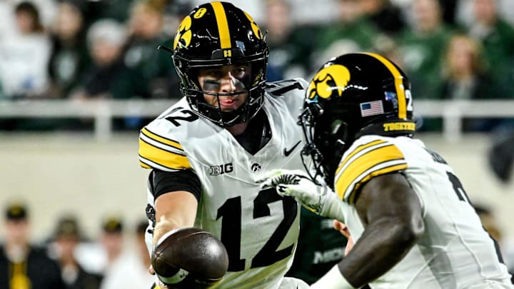 Iowa's Cade McNamara, left, hands off to Kaleb Johnson during the first quarter in the game against Michigan State on Saturday, Oct. 19, 2024, at Spartan Stadium in East Lansing.