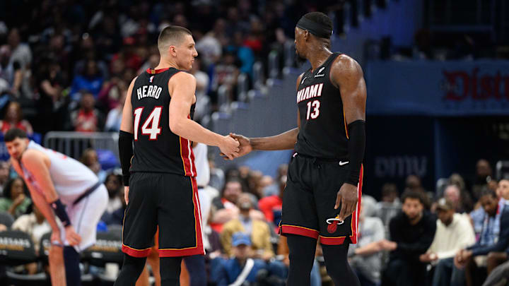 Mar 31, 2025; Washington, District of Columbia, USA; Miami Heat guard Tyler Herro (14) and center Bam Adebayo (13) react during the third quarter against the Washington Wizards at Capital One Arena. Mandatory Credit: Reggie Hildred-Imagn Images