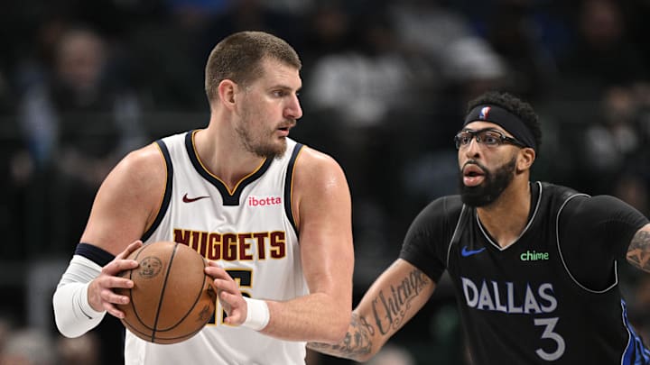Dec 23, 2025; Dallas, Texas, USA; Denver Nuggets center Nikola Jokic (15) looks to move the ball past Dallas Mavericks forward Anthony Davis (3) during the second half at the American Airlines Center.