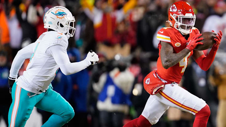 Jan 13, 2024; Kansas City, Missouri, USA; Kansas City Chiefs wide receiver Rashee Rice (4) runs the ball ahead of Miami Dolphins cornerback Kader Kohou (4) during the first half of the 2024 AFC wild card game at GEHA Field at Arrowhead Stadium. Ma