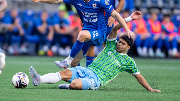Jul 31, 2025; Seattle, Washington, USA;  Seattle Sounders midfielder Obed Vargas (18) tackles Cruz Azul midfielder Jose Paradela (20) during the first half at Lumen Field. Mandatory Credit: Stephen Brashear-Imagn Images
