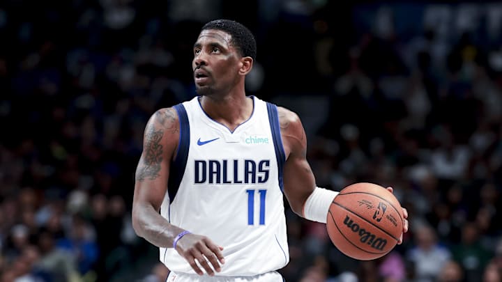 Dallas Mavericks guard Kyrie Irving dribbles the ball.