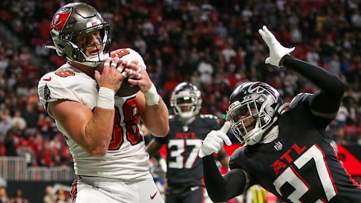 Dec 10, 2023; Atlanta, Georgia, USA; Tampa Bay Buccaneers tight end Cade Otton (88) catches a touchdown pass over Atlanta Falcons safety Richie Grant (27) in the second half at Mercedes-Benz Stadium. Mandatory Credit: Brett Davis-Imagn Images