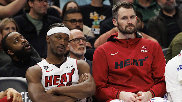 Apr 19, 2023; Milwaukee, Wisconsin, USA; Miami Heat forward Jimmy Butler (22), forward Kevin Love (42) and guard Gabe Vincent (2) look on from the bench during the fourth quarter against the Milwaukee Bucks during game two of the 2023 NBA Playoffs at Fiserv Forum. Mandatory Credit: Jeff Hanisch-Imagn Images