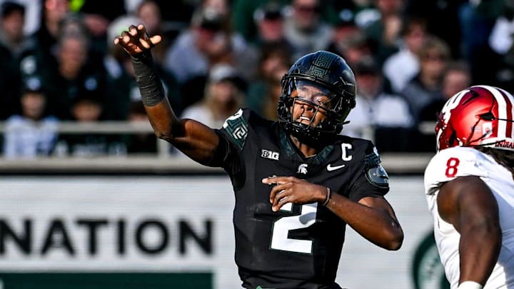 Michigan State's Aidan Chiles, left, throws a pass as Indiana's CJ West closes in during the first quarter on Saturday, Nov. 2, 2024, at Spartan Stadium in East Lansing.
