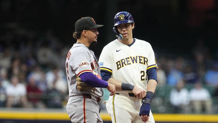 Jun 1, 2026; Milwaukee, Wisconsin, USA; Former teammates San Francisco Giants shortstop Willy Adames (2) and Milwaukee Brewers designated hitter Christian Yelich (22) chat at second base in the fourth inning at American Family Field. Mandatory Credit: Michael McLoone-Imagn Images