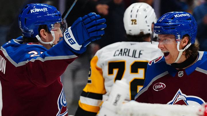 Oct 16, 2026; Denver, Colorado, USA;  Colorado Avalanche right wing T.J. Hughes (13) celebrates his first NHL goal with center Nathan MacKinnon (29) against the Pittsburgh Penguins in the second period at Ball Arena.  Mandatory Credit: Ron Chenoy-Imagn Images