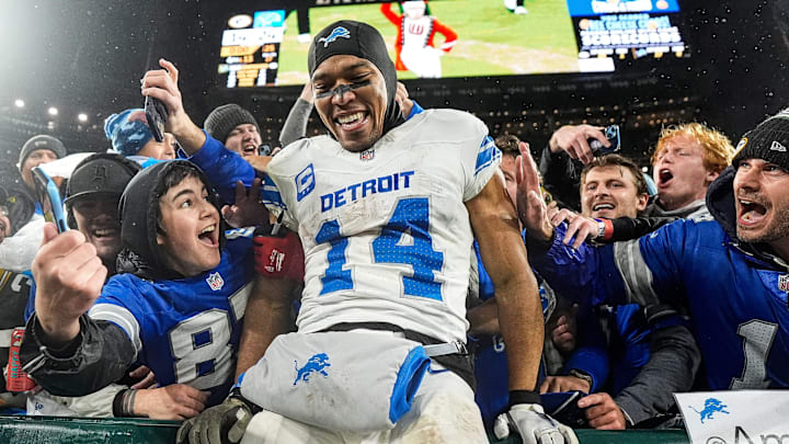 Detroit Lions wide receiver Amon-Ra St. Brown (14) leaps into Lions fans as they celebrate 24-14 win over Green Bay Packers at Lambeau Field in Green Bay, Wis. on Sunday, Nov. 3, 2024.