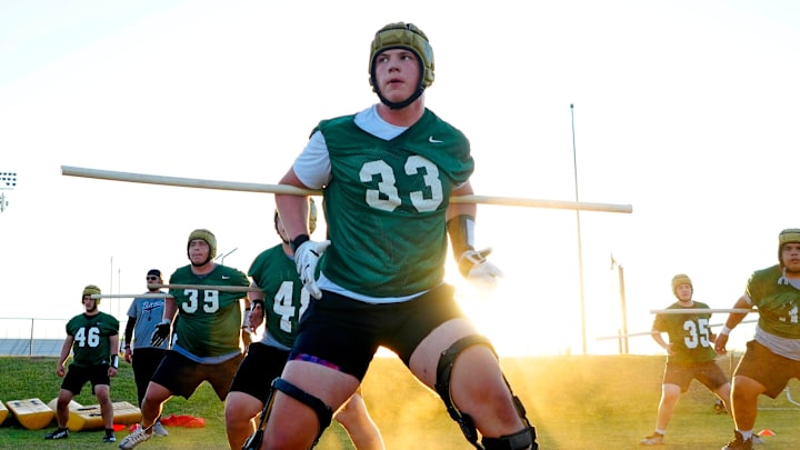 Basha offensive tackle Jake Hildebrand runs a drill during a practice at Basha High School on April 25, 2024.