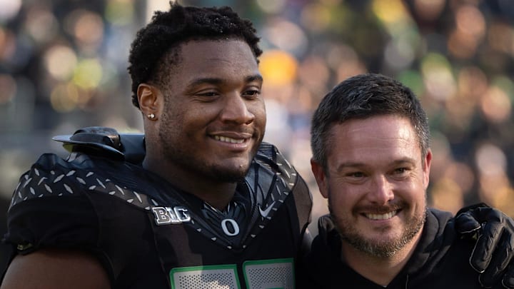 Oregon’s Isaiah World, left, takes a picture with coach Dan Lanning before the game against Southern California Nov. 22, 2025. Oregon’s Isaiah World, left, takes a picture with coach Dan Lanning before the game against Southern California Nov. 22, 2025.