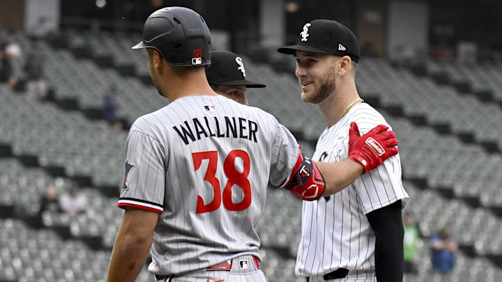 Minnesota Twins outfielder Matt Wallner (38) talks to Chicago White Sox pitcher Sean Burke (59) after hitting him with a line drive at Rate Field. 