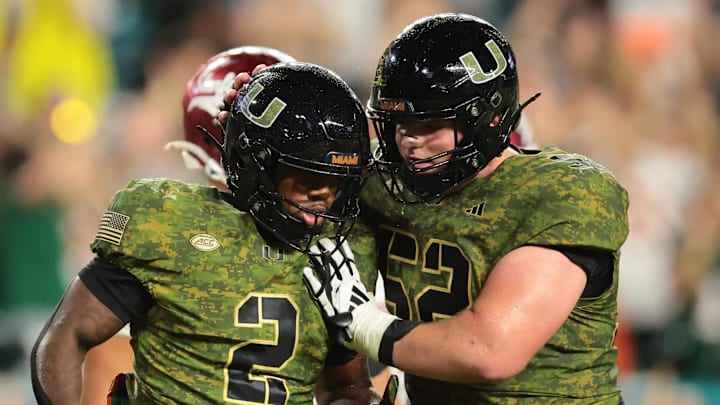 Oct 25, 2025; Miami Gardens, Florida, USA; Miami Hurricanes running back Jordan Lyle (2) celebrates with offensive lineman James Brockermeyer (52) after scoring a touchdown against the Stanford Cardinal during the fourth quarter at Hard Rock Stadium. Mandatory Credit: Sam Navarro-Imagn Images Oct 25, 2025; Miami Gardens, Florida, USA; Miami Hurricanes running back Jordan Lyle (2) celebrates with offensive lineman James Brockermeyer (52) after scoring a touchdown against the Stanford Cardinal during the fourth quarter at Hard Rock Stadium. Mandatory Credit: Sam Navarro-Imagn Images