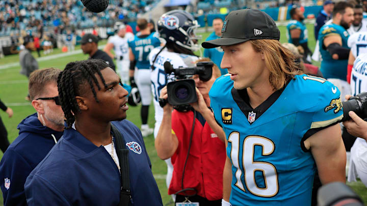 Jacksonville Jaguars quarterback Trevor Lawrence (16) greets Tennessee Titans quarterback Cam Ward (1), left, who was injured in the first quarter, after the game of an NFL football matchup at EverBank Stadium, Sunday, Jan. 4, 2026, in Jacksonville, Fla. The Jaguars defeated the Titans 41-7, capturing the AFC South title. [Corey Perrine/Florida Times-Union]