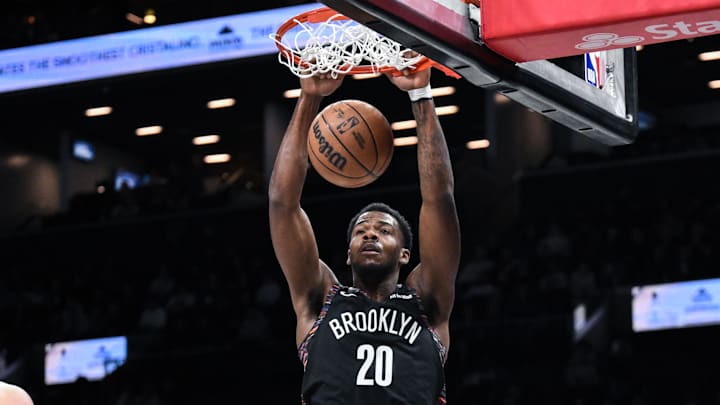 Dec 21, 2025; Brooklyn, New York, USA; Brooklyn Nets center Day'Ron Sharpe (20) dunks the ball against the Toronto Raptors during the first half at Barclays Center. Mandatory Credit: John Jones-Imagn Images