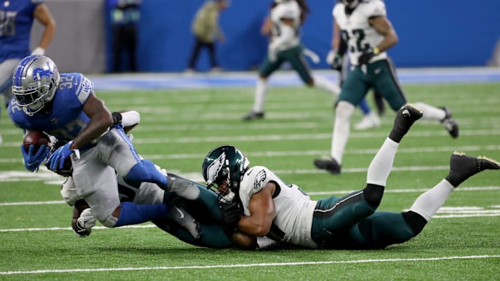 Detroit Lions running back D'Andre Swift (32) is tackled by Philadelphia Eagles linebackers Davion