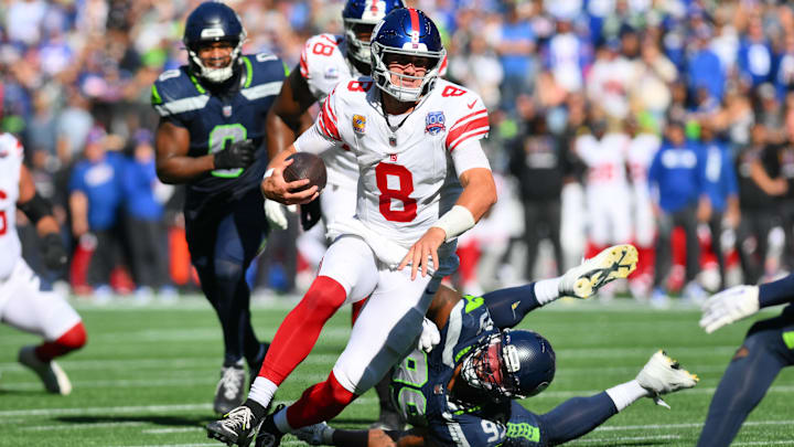 Oct 6, 2024; Seattle, Washington, USA; New York Giants quarterback Daniel Jones (8) carries the ball against the Seattle Seahawks during the first half at Lumen Field. Mandatory Credit: Steven Bisig-Imagn Images