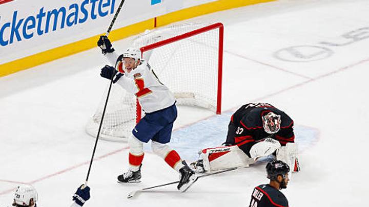 RALEIGH, NORTH CAROLINA - SEPT 29: Carter Verhaeghe #23 of the Florida Panthers celebrates a goal on Brandon Bussi #32 of the Carolina Hurricanes to win the game from Gustav Forsling #42 while Brady Tkachuk #8 celebrates during overtime of the game against Carolina Hurricanes at Lenovo Center on September 29, 2026 in Raleigh, North Carolina. (Photo by Jaylynn Nash/Getty Images)