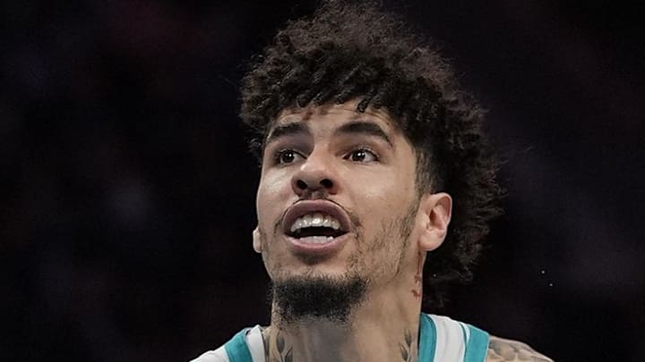 Charlotte Hornets guard LaMelo Ball drives to the basket against Orlando Magic guard Anthony Black.