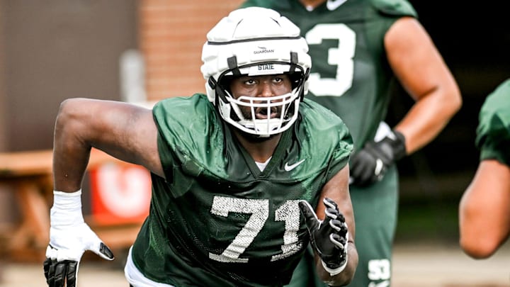 Michigan State's Kristian Phillips runs an offensive line drill during the first day of football camp on Tuesday, July 30, 2024, in East Lansing.