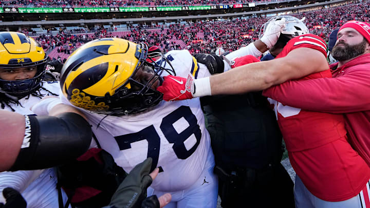 Ohio State Buckeyes and Michigan Wolverines fight following their 2024 meeting that Michigan won 13-10.