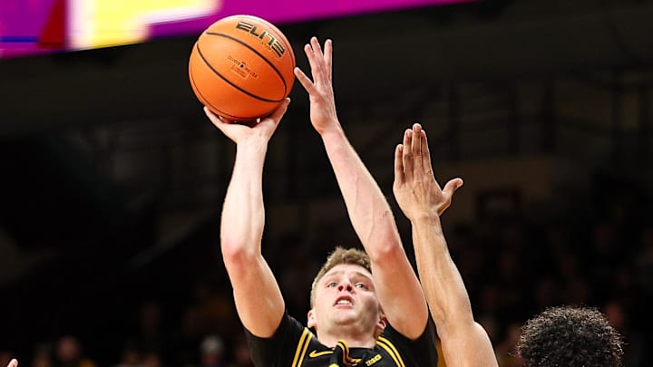 Jan 6, 2026; Minneapolis, Minnesota, USA; Iowa Hawkeyes guard Bennett Stirtz (14) shoots as Minnesota Golden Gophers guard Isaac Asuma (1) defends during the second half at Williams Arena. Mandatory Credit: Matt Krohn-Imagn Images Jan 6, 2026; Minneapolis, Minnesota, USA; Iowa Hawkeyes guard Bennett Stirtz (14) shoots as Minnesota Golden Gophers guard Isaac Asuma (1) defends during the second half at Williams Arena. Mandatory Credit: Matt Krohn-Imagn Images