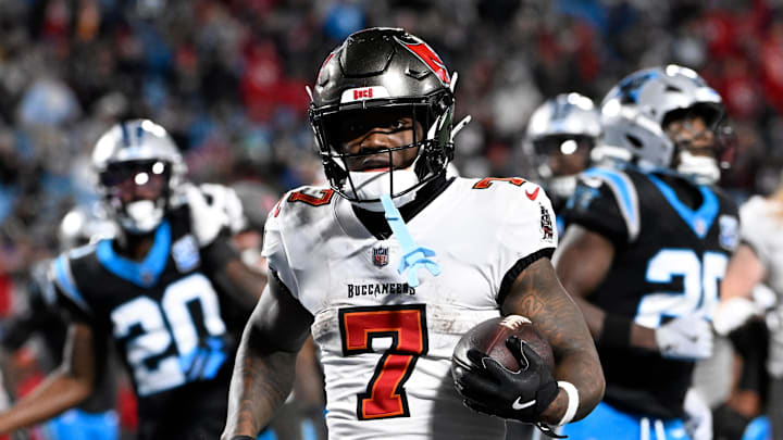 Dec 1, 2024; Charlotte, North Carolina, USA;  Tampa Bay Buccaneers running back Bucky Irving (7) scores a touchdown in the fourth quarter at Bank of America Stadium. Mandatory Credit: Bob Donnan-Imagn Images