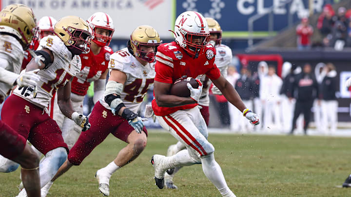 Nebraska  running back Rahmir Johnson carries the ball as Boston College linebacker Joe Marinaro (45) pursues during the first half.