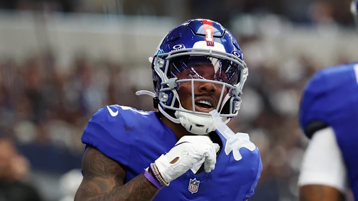 Sep 14, 2025; Arlington, Texas, USA; New York Giants wide receiver Malik Nabers (1) celebrates after scoring a touchdown against the Dallas Cowboys during the second quarter at AT&T Stadium.  