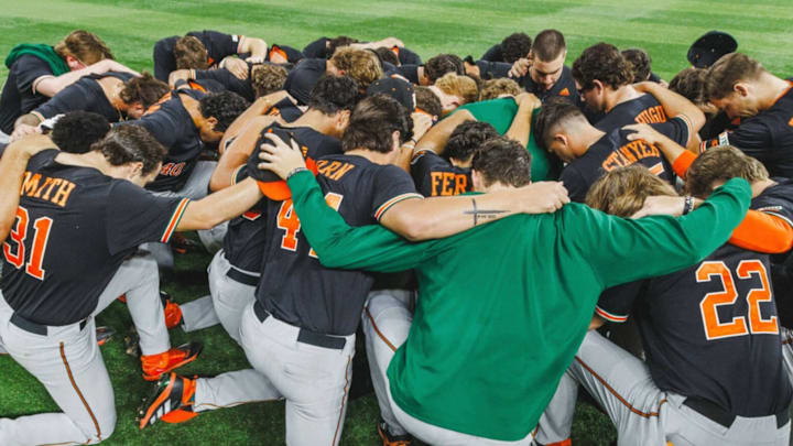 The Miami Hurricanes Baseball team praying after a tough loss against the UCF Knights in Orlando, Fla.