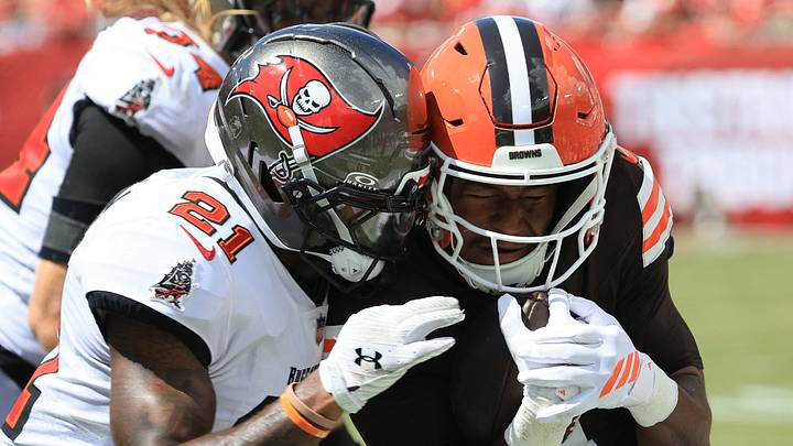 Tampa Bay Buccaneers cornerback Benjamin Morrison (21) tackles Cleveland Browns quarterback Deshaun Watson Tampa Bay Buccaneers cornerback Benjamin Morrison (21) tackles Cleveland Browns quarterback Deshaun Watson