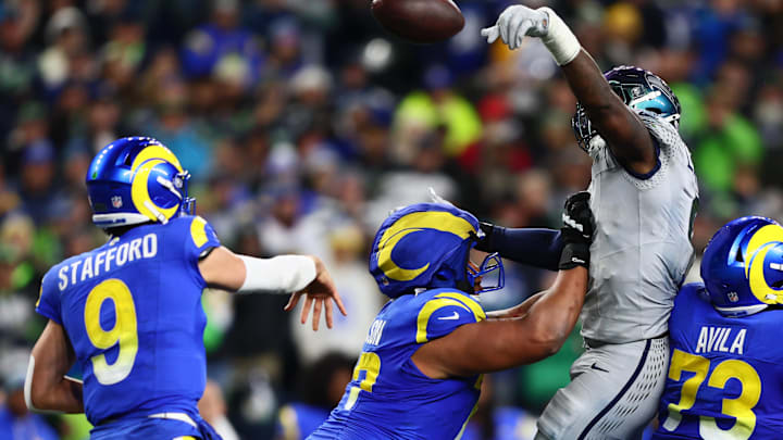 Dec 18, 2025; Seattle, Washington, USA;  Seattle Seahawks defensive end Demarcus Lawrence (0) blocks a pass by Los Angeles Rams quarterback Matthew Stafford (9) in the second half at Lumen Field. Mandatory Credit: Kevin Ng-Imagn Images