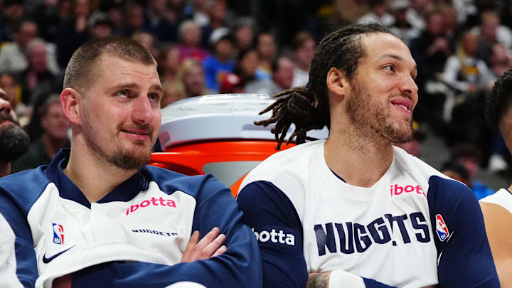Dec 23, 2024; Denver, Colorado, USA; Denver Nuggets center Nikola Jokic (15) and forward Aaron Gordon (32) and forward Michael Porter Jr. (1) on the bench in the fourth quarter against the Phoenix Suns at Ball Arena. Mandatory Credit: Ron Chenoy-Imagn Images