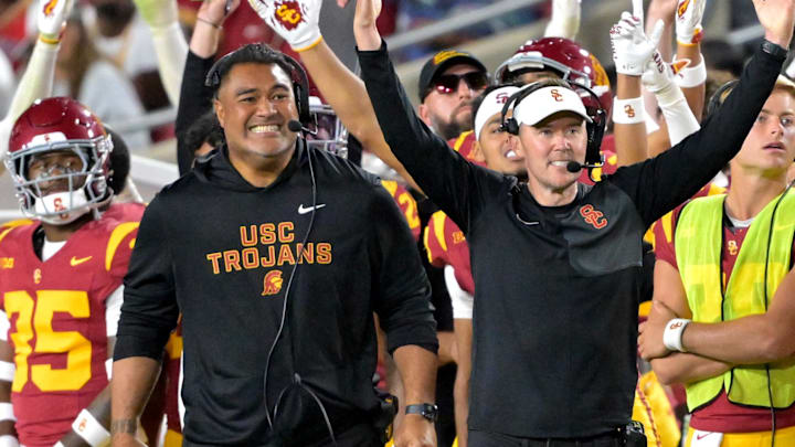 Oct 11, 2025; Los Angeles, California, USA; USC Trojans head coach Lincoln Riley (wearing white visor) celebrates along with defensive end coach Shaun Nua after kicker Ryon Sayeri (48) hit a 54-yard field goal in the second half against the Michigan Wolverines at United Airlines Field at the Los Angeles Memorial Coliseum. Mandatory Credit: Jayne Kamin-Oncea-Imagn Images Oct 11, 2025; Los Angeles, California, USA; USC Trojans head coach Lincoln Riley (wearing white visor) celebrates along with defensive end coach Shaun Nua after kicker Ryon Sayeri (48) hit a 54-yard field goal in the second half against the Michigan Wolverines at United Airlines Field at the Los Angeles Memorial Coliseum. Mandatory Credit: Jayne Kamin-Oncea-Imagn Images
