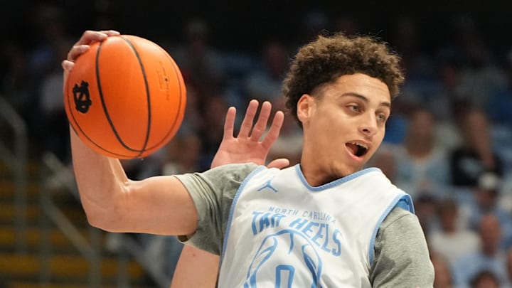 Oct 4, 2025; Charlotte, NC, USA; North Carolina Tar Heels guard Kyan Evans (0) grabs a rebound in the second half at Dean E. Smith Center. Mandatory Credit: Bob Donnan-Imagn Images