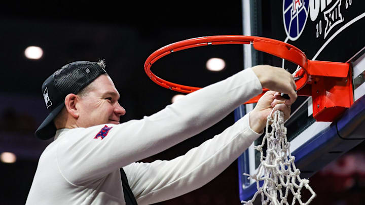 Mar 2, 2026; Tucson, Arizona, USA; Arizona Wildcats head coach Tommy Lloyd cuts down the net after they defeat the Iowa State Cyclones at McKale Memorial Center. Mandatory Credit: Aryanna Frank-Imagn Images Mar 2, 2026; Tucson, Arizona, USA; Arizona Wildcats head coach Tommy Lloyd cuts down the net after they defeat the Iowa State Cyclones at McKale Memorial Center. Mandatory Credit: Aryanna Frank-Imagn Images
