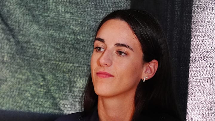 Caitlin Clark waits to speak at a press conference.