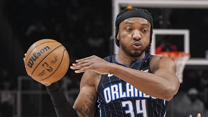 Orlando Magic center Wendell Carter Jr. dribbles against Atlanta Hawks guard Terance Mann.