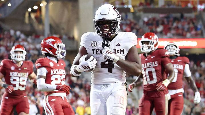 Oct 18, 2025; Fayetteville, Arkansas, USA; Texas A&M Aggies running back Rueben Owens II (4) rushes for a touchdown in the fourth quarter against the Arkansas Razorbacks at Donald W. Reynolds Razorback Stadium. Mandatory Credit: Nelson Chenault-Imagn Images
