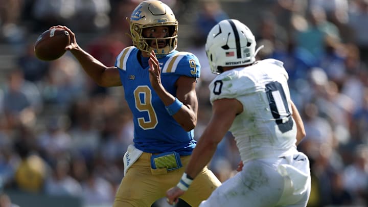 Oct 4, 2025; Pasadena, California, USA;  UCLA Bruins quarterback Nico Iamaleava (9) throws a pass as Penn State Nittany Lions linebacker Dominic Deluca (0) pressures him during the fourth quarter at Rose Bowl. Mandatory Credit: Kiyoshi Mio-Imagn Images