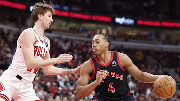 Feb 19, 2026; Chicago, Illinois, USA; Toronto Raptors forward Scottie Barnes (4) is defended by Chicago Bulls forward Matas Buzelis (14) during the first half at United Center. Mandatory Credit: Kamil Krzaczynski-Imagn Images