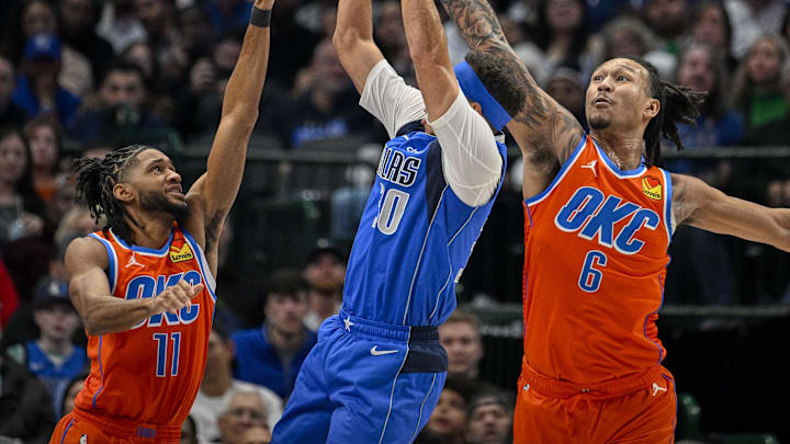 Dec 2, 2023; Dallas, Texas, USA; Dallas Mavericks guard Seth Curry (30) attempts to shoot over Oklahoma City Thunder guard Isaiah Joe (11) and forward Jaylin Williams (6) during the second quarter at the American Airlines Center. Mandatory Credit: Jerome Miron-Imagn Images