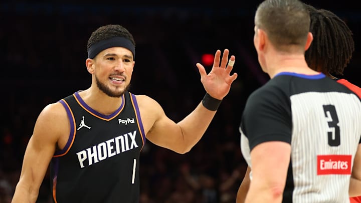 Apr 14, 2026; Phoenix, Arizona, USA; Phoenix Suns guard Devin Booker (1) argues with a referee against the Portland Trail Blazers in the second half during the play-in rounds of the 2026 NBA Playoffs at Mortgage Matchup Center. Mandatory Credit: Mark J. Rebilas-Imagn Images